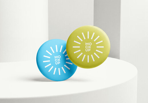 Two Round Matte Pin Badge Button Mockups Floating on White Minimalist Studio Pedestal for Merchandising Brand Display