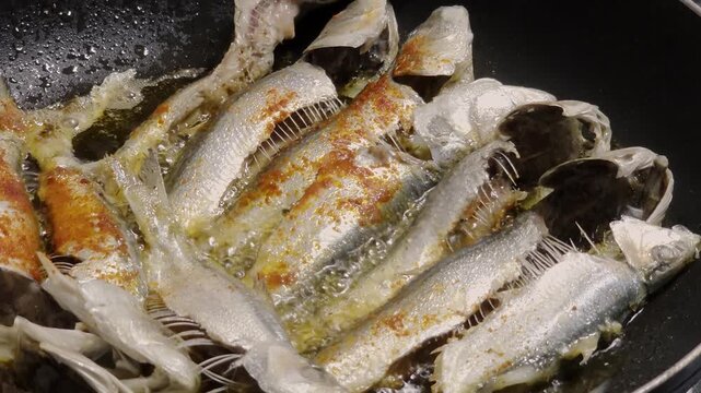 Frying Sardine Fish In Spicy Oil in Pan

