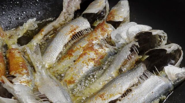 Frying Sardine Fish In Spicy Oil in Pan

