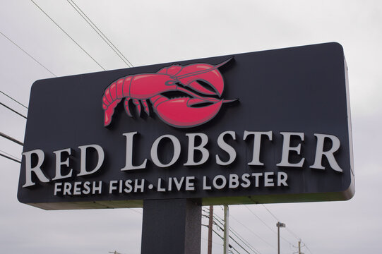 Red Lobster Restaurant Sign With Lobster Logo Advertising Fresh Fish and Live Lobster. .Editorial Use Only Auburn, AL USA May 12, 2026.bold lettering promoting fresh fish and live lobster at a roadsid