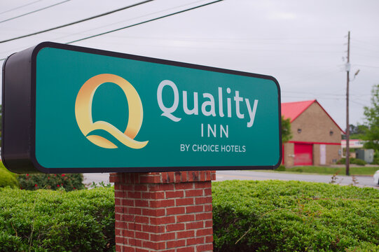 Quality Inn Hotel Sign Outside Lodging Property Near Roadside With Brick Post and Green Landscaping Editorial Use Only Auburn, AL USA May 12, 2026. representing lodging, travel accommodations, motel b