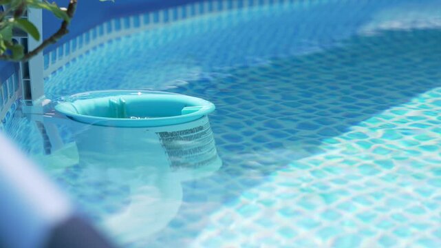 Floating Pool Skimmer in Clear Blue Backyard Swimming Pool