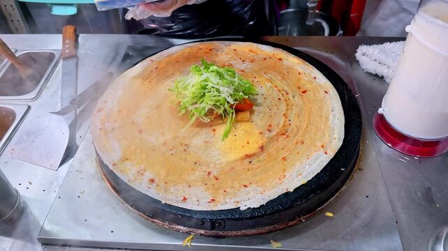 Street food vendor making Chinese jianbing crepe in Chongqing