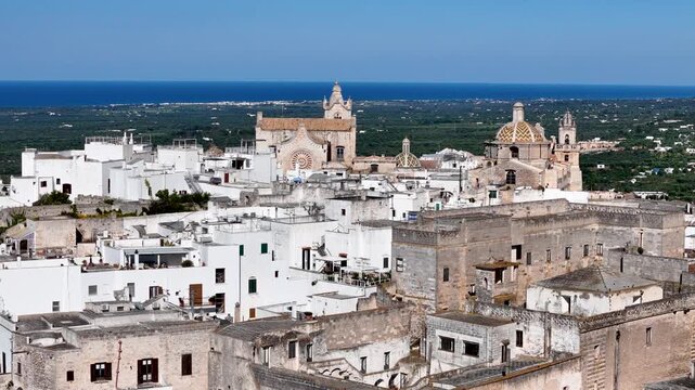 Ostuni, the White City of Puglia. Aerial 4K drone video footage with view of panorama of historic Italian architecture and Mediterranean landscape. Whitewashed old town