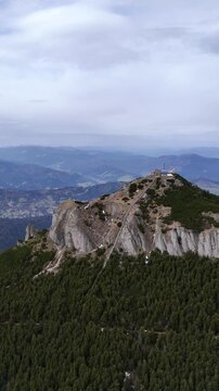 Toaca Peak wide aerial view forested slopes Ceahlau Romania