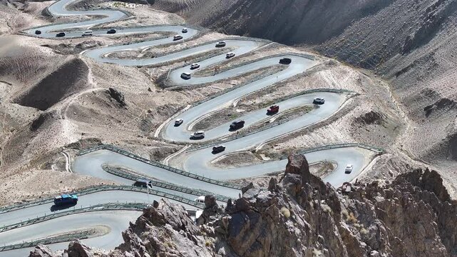 Cars on Winding Mountain Switchback Road in Rocky Desert