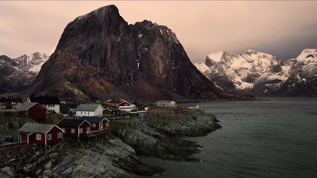 Scenic Norwegian fishing village nestled among dramatic snow-capped mountains