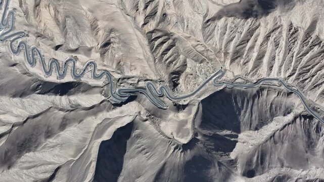Winding Mountain Road Through Barren Desert Hills