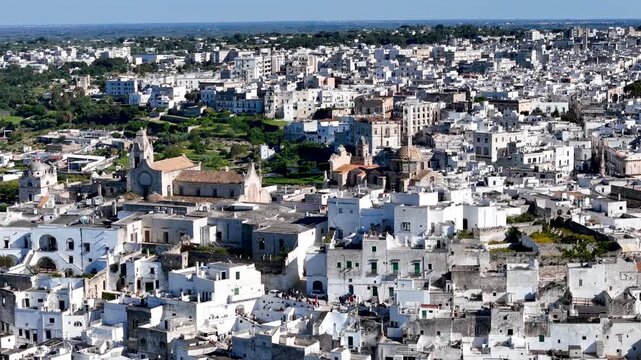 Ostuni, the White City of Puglia. Aerial 4K drone video footage with view of panorama of historic Italian architecture and Mediterranean landscape. Whitewashed old town