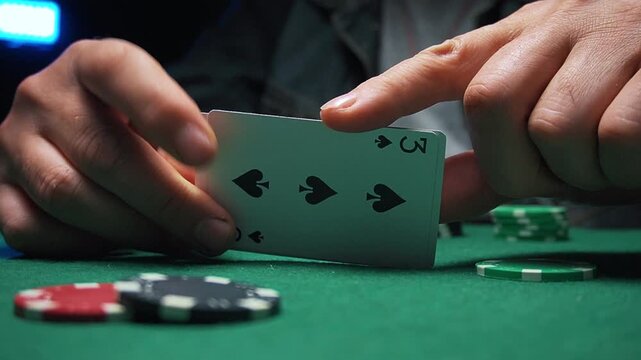 During a poker game on a green felt table, two pairs fall out of the hands, and colorful poker chips are scattered around, creating an exciting gaming atmosphere