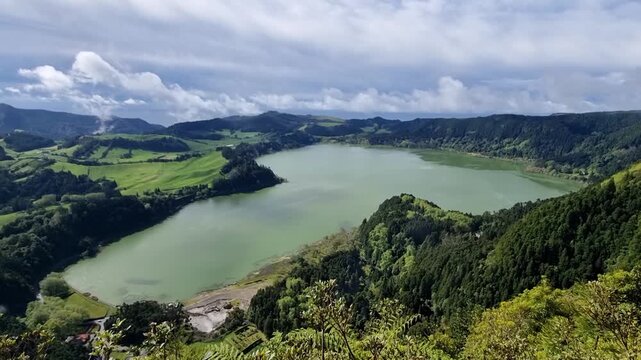 Panoramic green valley with large lake, forested slopes and dramatic clouds. Lagoa das Furnas isla Sao Miguel dos A&ccedil;ores