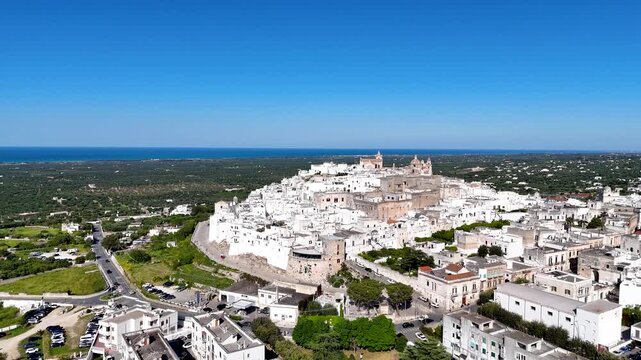 Ostuni, the White City of Puglia. Aerial 4K drone video footage with view of panorama of historic Italian architecture and Mediterranean landscape. Whitewashed old town
