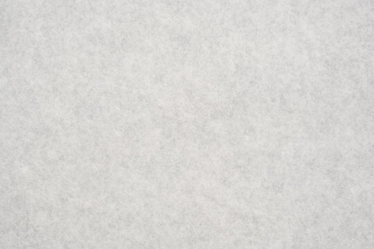 Close up of white textured felt fabric showing abstract soft surface
