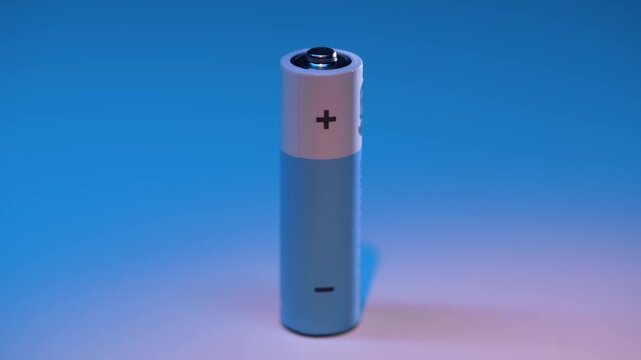 Ordinary AA battery isolated on blue background