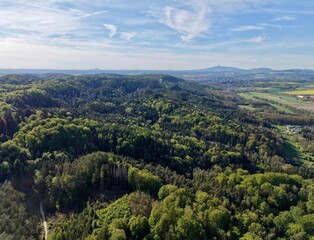Obraz premium Wide green valley with mountains. Large green plains surrounded by distant peaks and curved pathways