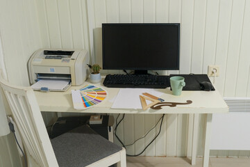 Fototapeta premium Remote workplace. Modern creative designer home workspace. Laptop, coffee cup, and color guide palette on desk. Remote work. Perfect for business, study, learning or productivity. Home Office Setup.