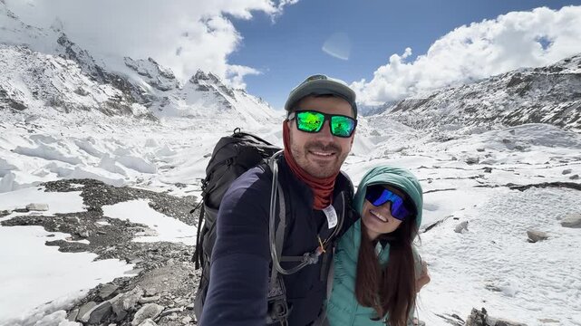 Happy couple at snowy Everest Base Camp in Himalayas, Nepal