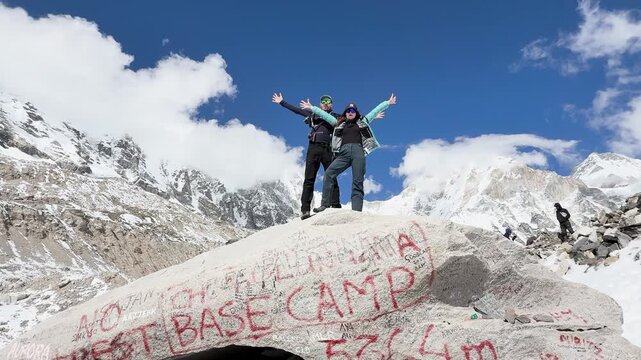 Happy couple on the rock at Everest Base Camp in Himalayas, Nepal