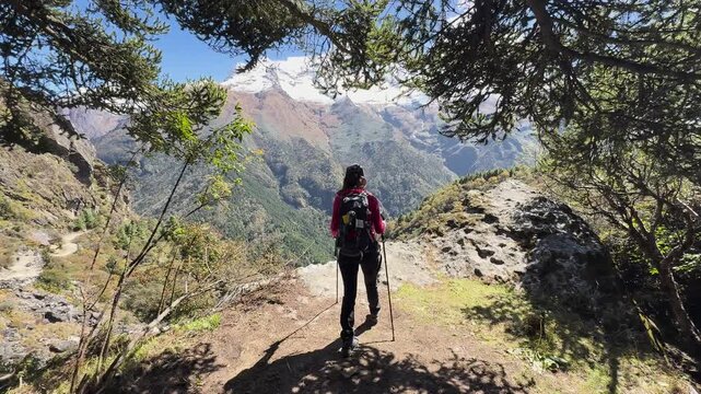 Hiker approaching rocky outcrop in Himalayas, Nepal