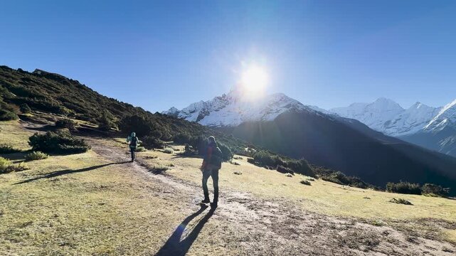 Hikers with trekking poles walking Everest Base Camp trail in Himalayas, Nepal