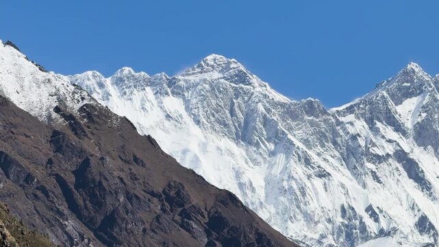 Majestic Nuptse, Everest and Lhotse peaks behind brown mountain ridge, Nepal