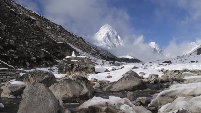 Pumori mountain peak above glacial stream in Himalayas, Nepal