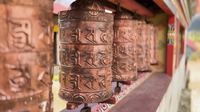 Copper Buddhist prayer wheels at mountain monastery in Himalayas, Nepal