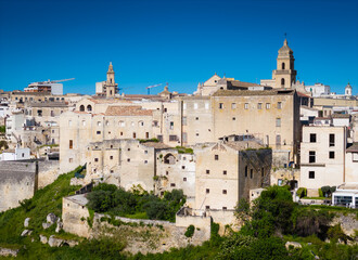 Fototapeta premium Gravina in Puglia. Aerial drone panorama view of historic Italian townscape with Gravina di Matera river canyon landscape and Apulian architecture