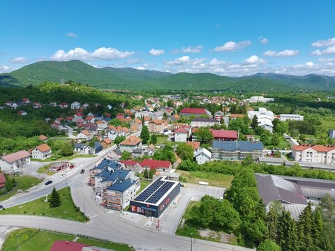 Aerial drone view of Gračac town surrounded by green mountains in Croatia