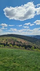 Fototapeta premium La Montagne limousine (avec le Plomb du Cantal en arrière-plan) vue depuis le sommet du Suc au May un bel après-midi de printemps (Limousin)