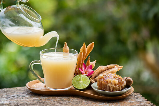 Fingerroot rhizomes and fingerroot juice mix lemon juice and honey on natual background.
