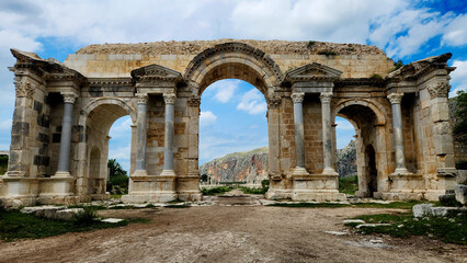 Fototapeta premium The unique three-arched Victory Gate to the ancient Anavarza city in Dilekkaya village of Kozan district in Adana province (Turkey). Once marked the entrance to one of largest Roman cities in the anci