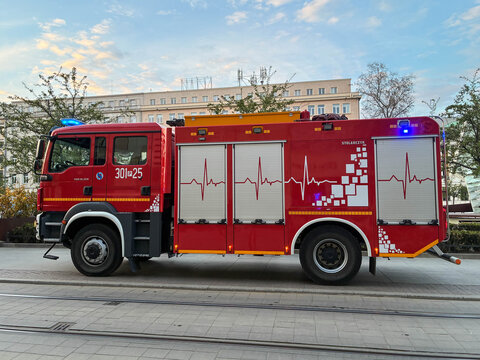 Poznan, Poland - April 16,2026: A Stolarczyk fire engine truck with a heartbeat pattern graphic stands on a city street representing professional emergency rescue services today