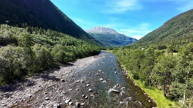 FPV drone flight over Rjukan river toward Gaustatoppen peak, Telemark Norway