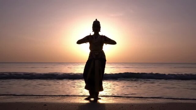 Traditional Indian dancer performing classical Bharatanatyam on beach at sunset, silhouette against golden sun, ocean waves, cultural performance, peaceful atmosphere