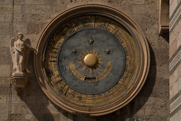 Obraz premium Historic astronomical clock on the stone wall of Messina Cathedral bell tower in Sicily, Italy