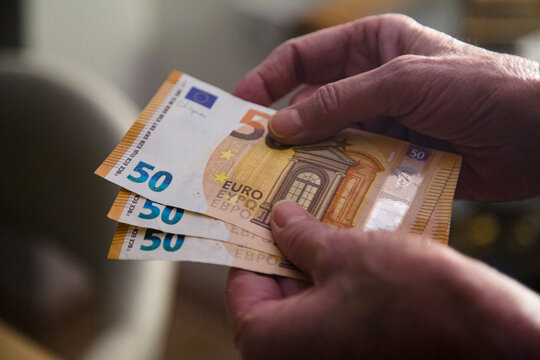 Hand Holding 150 EURO Banknote