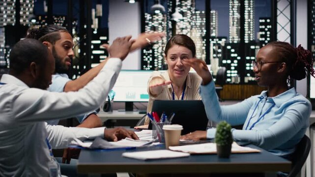 Diverse group of people uniting hands and celebrating a victory, breakthrough in project management to meet business objectives. Coworkers proud about efficient teamwork and success.