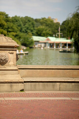Obraz premium Serene Waterside With Trees. Tranquil Lakeside View With Boats And Sunlight new york