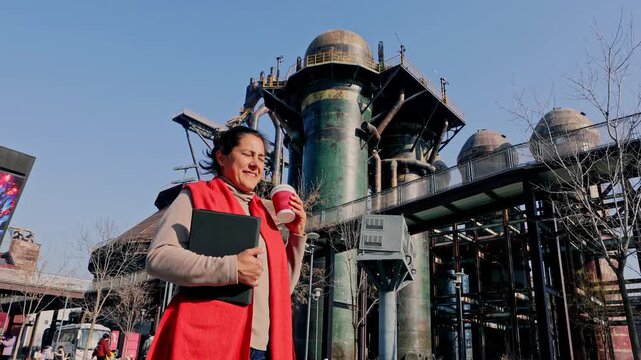 Female engineer drinking coffee on a break at a repurposed industrial site