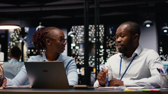 Black business team uniting forces and solving administrative tasks, ensuring strategy planning for project management. Man and woman colleagues sharing business intel for research.