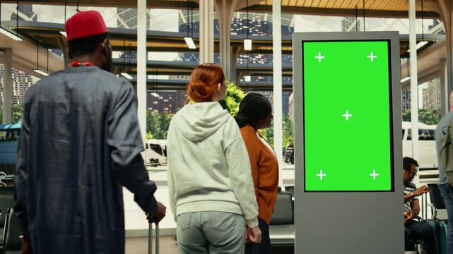 Green screen in public transportation station with passengers during weekday commute in a busy city environment. Human flow and movement create realistic urban lifestyle scene.