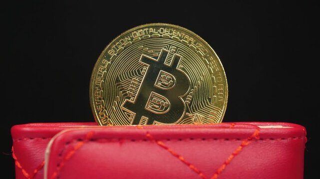 Gold bitcoin coin stored in a digital crypto wallet representing blockchain technology and bitcoin mining concept