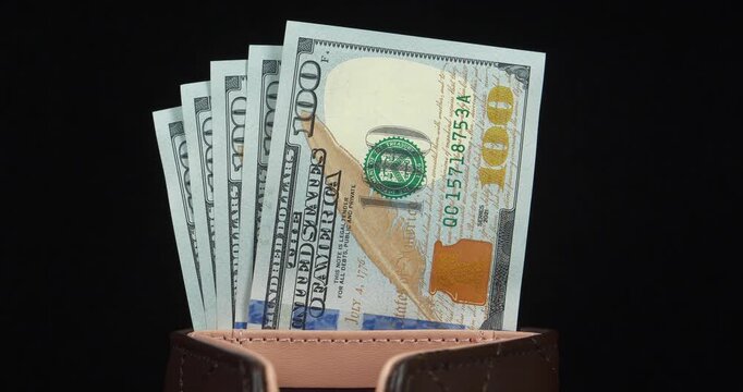 Five new 100 dollar bills. American dollars in wallet. Cash. 500 dollars in wallet. New hundred dollar bills in leather wallet