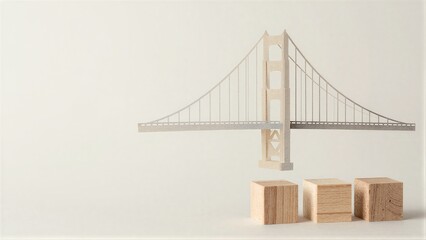 Obraz premium Mini bridge model hovers above wooden blocks symbolizing