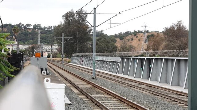 Empty Light Rail Tracks With Trees And Hills