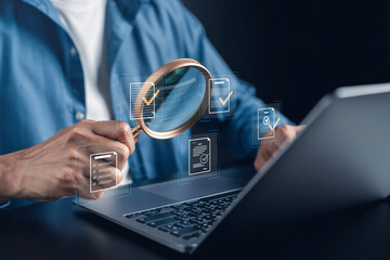 Digital document quality assurance and compliance audit management. Man holding magnifying glass over laptop for file verification and checkmark approval. © Kiattisak