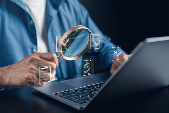 Digital document quality assurance and compliance audit management. Man holding magnifying glass over laptop for file verification and checkmark approval.