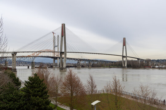 Cable-Stayed Bridge Spanning the Fraser River With Traffic and City Skyline in New Westminster Vancouver