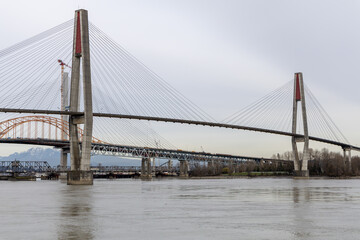 Fototapeta premium Cable-Stayed Bridge Over River With Concrete Pylons Near New Westminster, Vancouver, BC